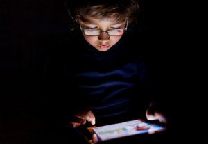 boy reading in the dark