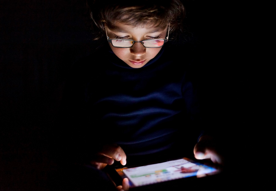 boy reading in the dark